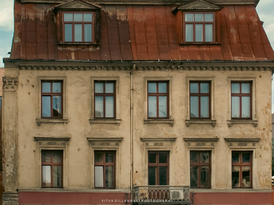 a weathered facade and intricate&nbsp;windows