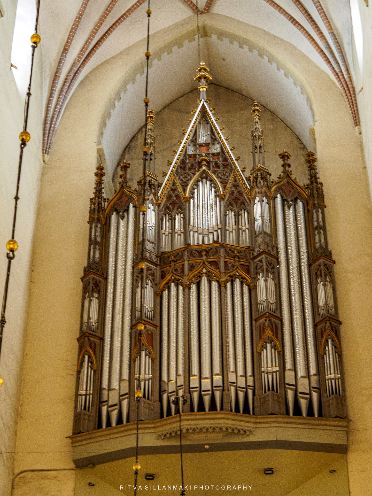 Historic church organ beneath vaulted Gothic arches